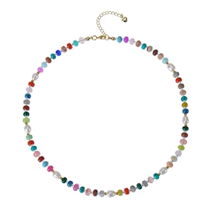 Detail of colorful gemstone beads necklace with freshwater pearls and a heart pendant