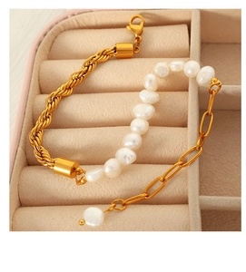 Detail of elegant gold twisted chain and pearl拼接 bracelet in a pink jewelry box drawer