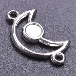 Macro shot of silver crescent moon pendant with circular base for DIY jewelry making