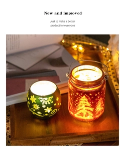 Close-up of decorative Christmas glass candle holders with snowflake and tree patterns