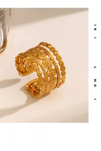 Detail of 18K gold-plated wide ring showing floral engraving and multi-layer texture
