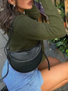 Chic black leather crescent handbag with gold logo and adjustable shoulder strap