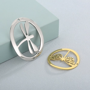Macro detail of gold and silver hollow dragonfly pendants for DIY jewelry making