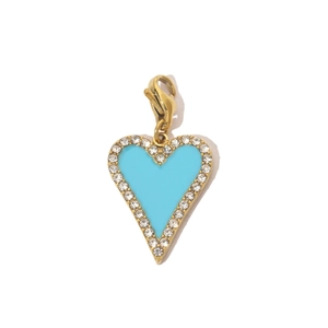 Detail of turquoise heart pendant in gold finish with crystal inlay and lobster clasp