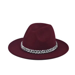Detail of burgundy wool fedora hat featuring a chunky marble-textured silver chain band