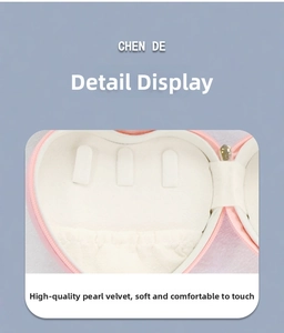 Detailed interior of heart shaped jewelry box with velvet ring slots and pink PU finish