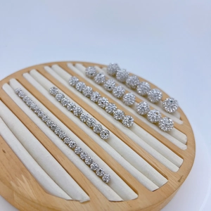 Macro shot of silver zircon pavé spacer beads in various sizes on a wooden tray