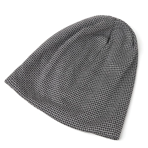 Detail of the high-elasticity knit texture on this black and white grid pattern beanie
