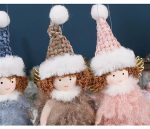 Close-up of three plush Christmas angel ornaments in grey, brown, and pink with glitter wings