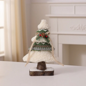 Dettaglio di un mini albero di Natale in maglia con texture morbide e base in legno