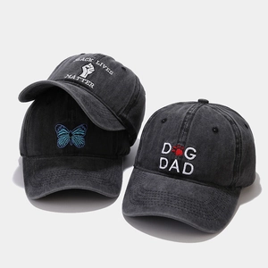 Detailed view of washed grey cotton baseball caps featuring high-quality custom embroidery