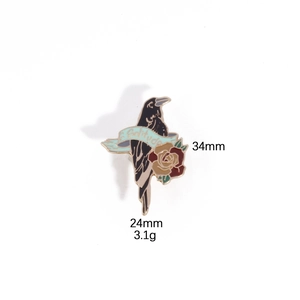 Detail view of gothic raven and rose metal brooch with 34mm by 24mm size dimensions