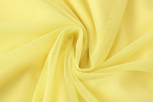 Detail of pale yellow layered mesh fabric showing breathable texture and fine grid density