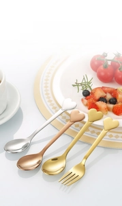 Detail of heart-shaped handle stainless steel spoons and forks in various finishes