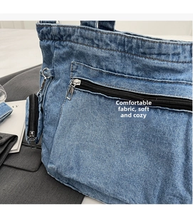 Detail of blue denim tote bag with silver zipper pocket and matching coin purse charm