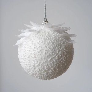 Macro detail of white textured Christmas ball with floral petals and silver hanging cap
