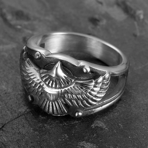 Vintage stainless steel eagle ring with detailed wings in retro punk style on stone