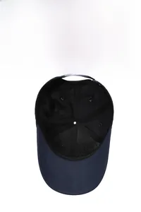 Internal structure of navy blue cotton baseball cap showing seams and ventilation holes