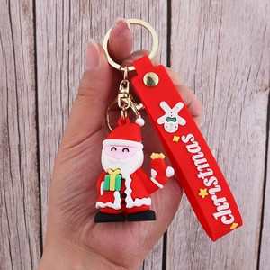 Detail of 3D Santa Claus PVC keychain with red silicone strap and gold metal clasp