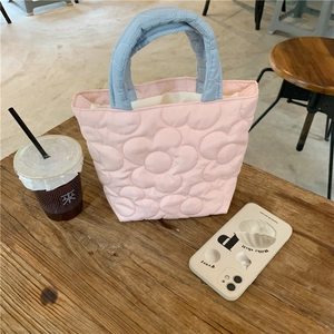 Detailed view of quilted flower pattern on the pink and blue padded mommy handbag