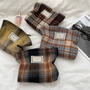 Flat lay of retro plaid cosmetic bags in four colors with high-quality wool texture