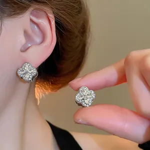 Elegant silver clover hoop earrings with sparkling cubic zirconia in a minimalist style