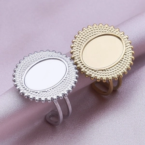 Detail of gold and silver oval rings with beaded edges on purple silk background