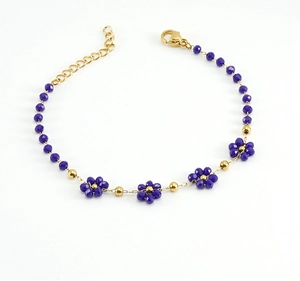 Detail of 18K gold-plated stainless steel chain with blue crystal flower bead patterns