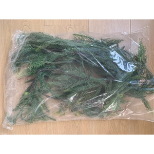 Detailed view of artificial green pine branches with PE needles for festive decoration