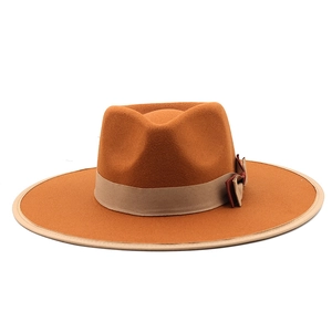 Detail view of the contrasting ribbon and bow on this stylish wide brim cashmere fedora