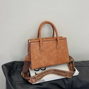 Vintage brown leather tote bag with wide shoulder strap and gold-tone hardware detail