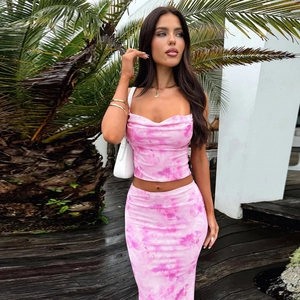 Detail of pink tie-dye two-piece set featuring cropped halter top and high-waist maxi skirt