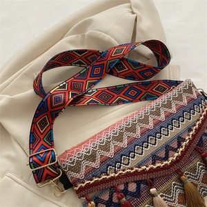 Detail of bohemian shoulder bag with fringe tassel, woven texture and geometric strap