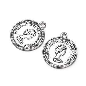 Macro shot of silver coin charms featuring Queen Elizabeth II profile for DIY jewelry