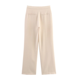 Detail view of beige trousers back side featuring straight leg cut and decorative pockets