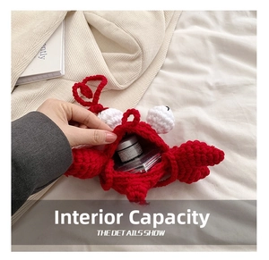 Detail showing the internal capacity of the red crochet crab crossbody bag for children