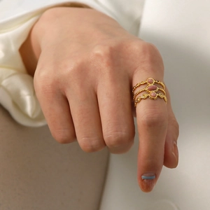 French vintage adjustable gold layered ring with pink stones on a model's hand
