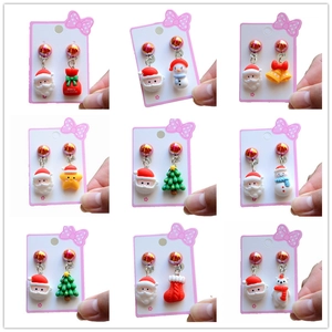 Set of Christmas clip-on earrings for girls featuring Santa, snowman, and tree designs