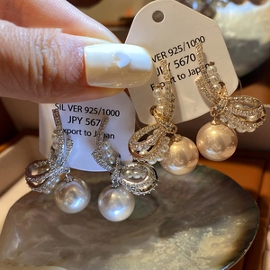 Elegant 925 silver bow stud earrings with zircon crystals and large round pearls