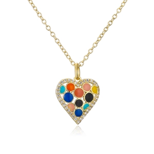 Macro shot of 18K gold plated heart pendant with colorful crystals and sparkling diamonds