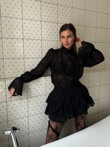 Elegant black lace set with lantern sleeves, turtleneck top, and tiered ruffle skirt