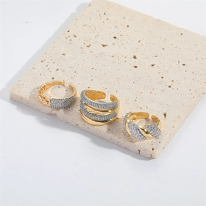 Minimalist gold-toned adjustable ring set with white cubic zirconia on stone tray