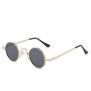 Retro small round metal sunglasses with gold frame and dark lenses for vintage fashion style