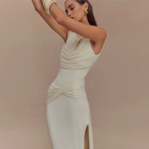 Detail view of white pleated sleeveless maxi dress with high side slit and elegant drape