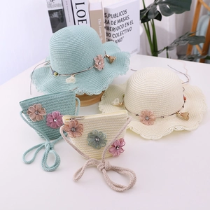 Detail of children's straw sun hat and matching bag with mesh floral decorations