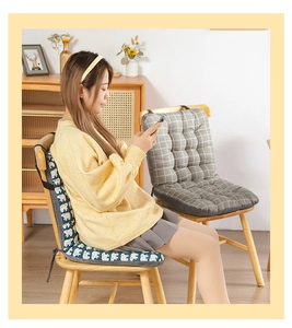 Detail of integrated chair cushion with elephant prints and straps on a wooden chair