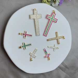 Detailed view of various 18k gold plated cross pendants with colorful zircon stones