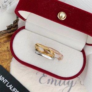 Macro shot of three geometric faceted rings with Je t'aime engraving in a velvet box