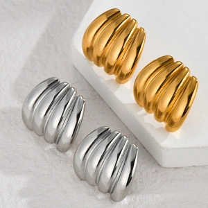 Macro view of irregular floral metal studs in gold and silver finish on stone texture