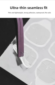 Macro detail of ultra-thin transparent nail adhesive tabs being picked up with purple tweezers